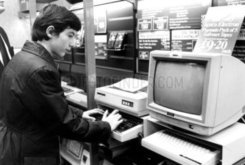 Boy looking at a computer  WH Smith  December 1984.