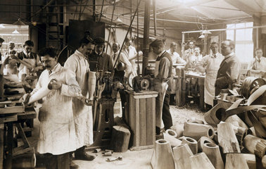 Making wooden prosthetic limbs during World War One  c 1915-1918.