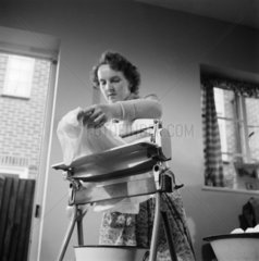 Woman using a mangle  1955.
