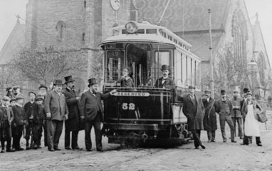 Men and children standing by a tram  c 1900s.