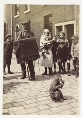 Organ grinder and his monkey  c 1920.