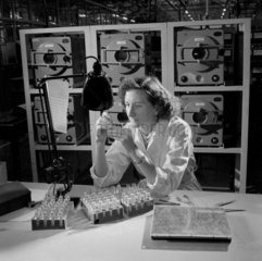 A female worker inspects a Magnatron  Mullard Ltd   1955.