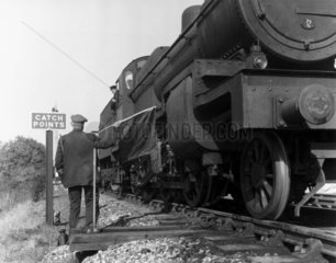Train passing over secured catchpoints  Shepton Mallet  Somerset  1957.