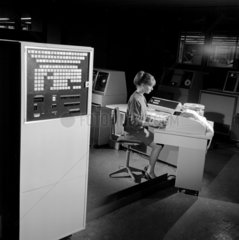 English Electric computer systems  a female progammer typing at console.
