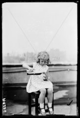 Little girl pouring whisky  1932.