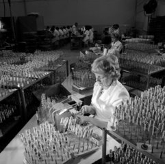 Women in Mullard workshop assemble electron plate to gun of cathode ray.