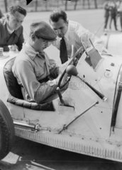 A racing driver writing in a Bugatti racing car  Berlin  1932.