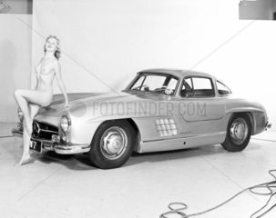 Nude model and Mercedes wing-door car  c 1961.