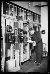 Man checking an automatic telephone exchange  1933.
