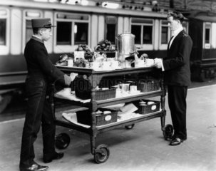 Two London and North Western Railway attendants with trolley  1908.