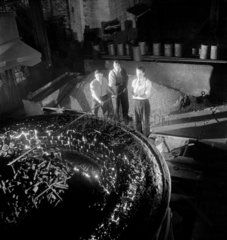 Workers raking slag at steel furnace  United Steel  Sheffield  1950.