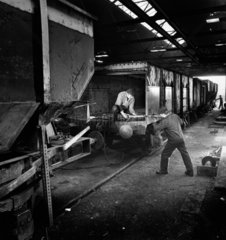 Interior of repair shop with men rivetting rail wagons  Swansea  1961.