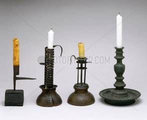 A selection of four candlesticks with candles  c 18th century .