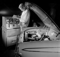 A mechanic Crypton tunes a Ford Corsair car at a London Garage.