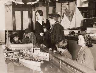 Boats on a miniature lake  Gamages Department Store  London  1920s.