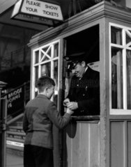 Small boy at York station having his ticket clipped  York  November 1951.