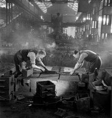 Two moulders prepare box in iron foundry  1950
