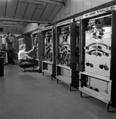 Model 803 Computer: female engineer with bank of Panelit tape units.