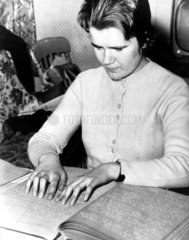 Blind girl reading Braille  1962. 'Eighteen