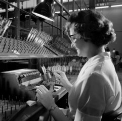 A women worker tests a cathode ray gun assembly  Mullard Ltd  1963.