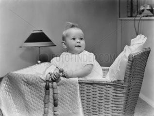Baby in a cot  1956.