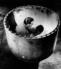 A welder works inside large steel vessel  Leeds  1966.
