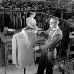 A tailor makes final inspection of jacket  Burton Menswear  Leeds 1960