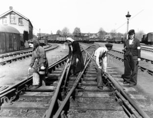 Women oiling tracks on the Great Western Ra