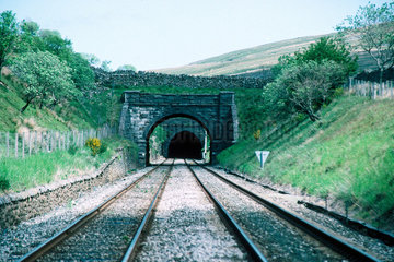 Railway line heading into a tunnel.