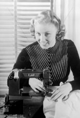 Woman using a sewing machine  1949.