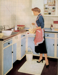 Woman in a fitted kitchen  1955.