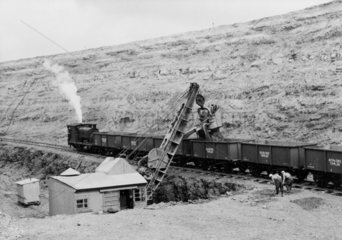 Train of iron ore tippler wagons in a quarry.