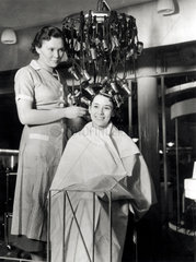 Demonstrating a new hairdressing machine  Olympia  23 September 1934.