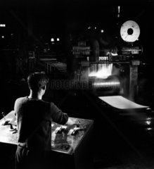 An operator works on hot steel plate rolling machine  1961.