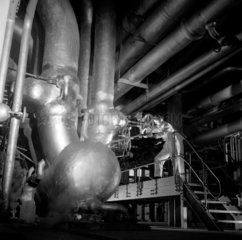 Worker with great pipes in powerhouse basement   ICI Wilton   1955