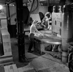Two female workers loading furnace brick moulds for kiln  Jarrow  1957.