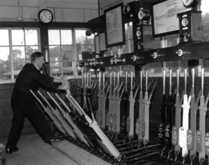 Operating the points levers at Horsted Keynes signal box  c 1955.