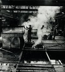 Tannery workers lift hides in steam  Beverley  1954.