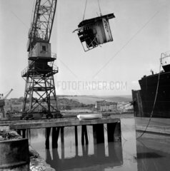 A crane lifts a section of the liner SS Britannic at the breakers yard  1961.