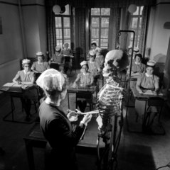 Preliminary training school for nurses  sister in class room with skeleton.