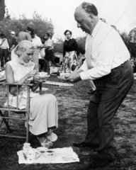 Grace Kelly and Alfred Hitchcock having tea  1955.