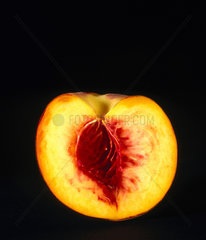 A peach  cut in half  with the stone removed  1990s.