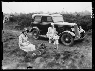 Family with their car in the country  1934.