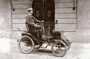 C S Rolls sitting in his Peugeot Voiturette  c 1900.