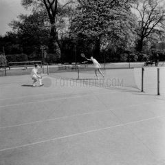 Two men 'playing tennis'  1955
