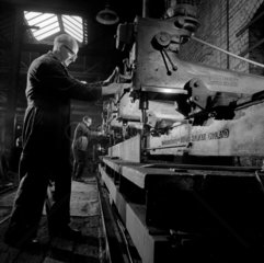 Two fitters at a Kitchen and Wade lathe drill cut large girder  1966.