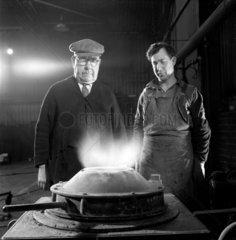 Two foundry men before metling crucible  Locomotive works  1957