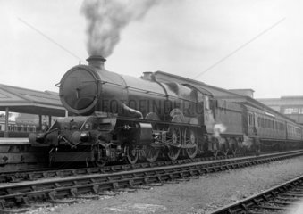 Steam locomotive with carriages  c 1930s.