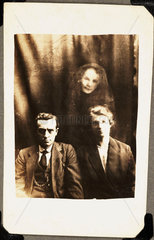 Couple with female 'spirit'  c 1920.