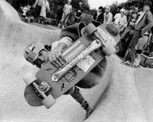 Skateboarder pulling off a trick at a skate park  20 November 1978.